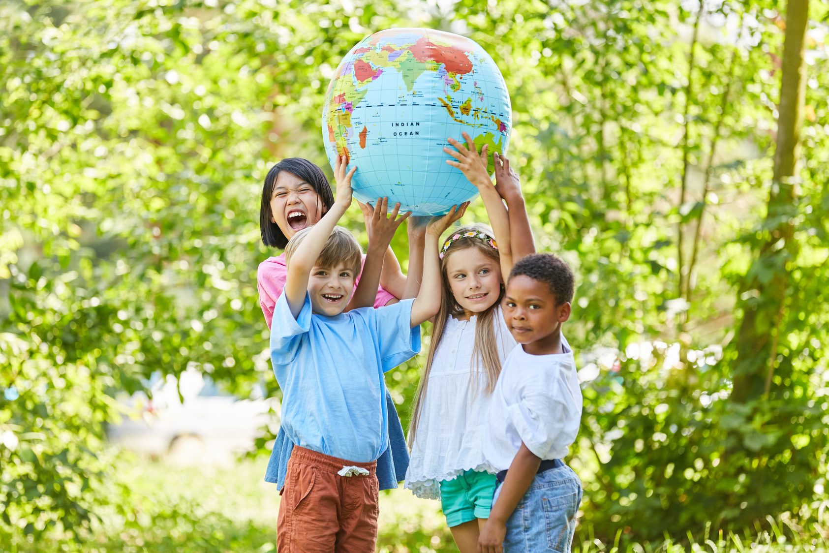 International Group of Children Holds Globe